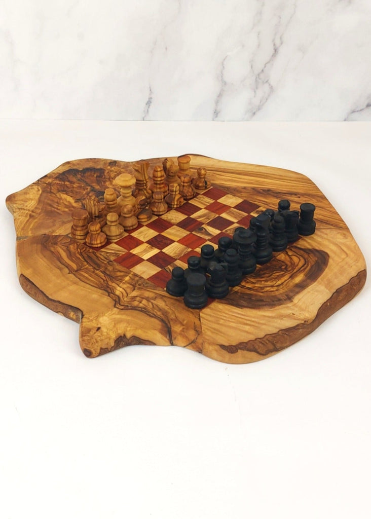 an olive wood chess board featuring red and brown squares, paired with handcrafted black and brown olive wood chess pieces