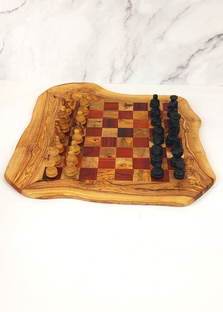 an olive wood chess board featuring red and brown squares, paired with handcrafted black and brown olive wood chess pieces