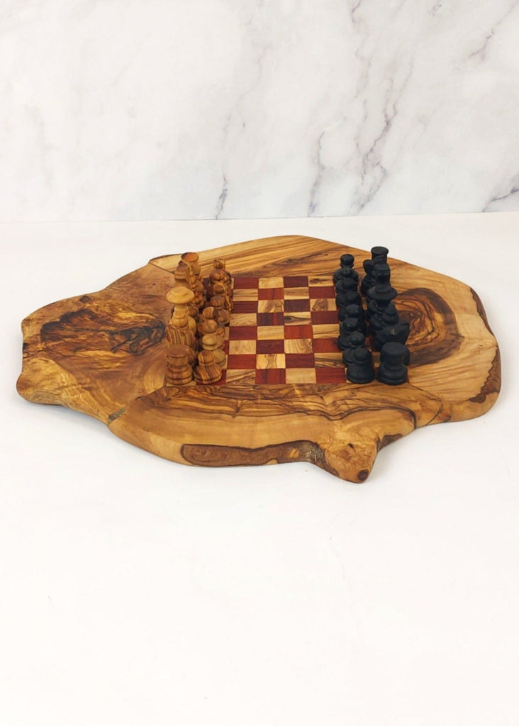 an olive wood chess board featuring red and brown squares, paired with handcrafted black and brown olive wood chess pieces