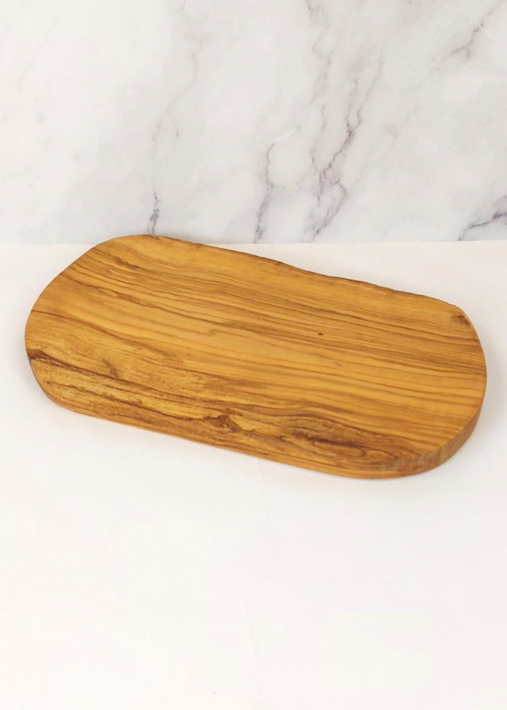 A rustic live edge cheese board, showcasing a unique natural wood grain pattern