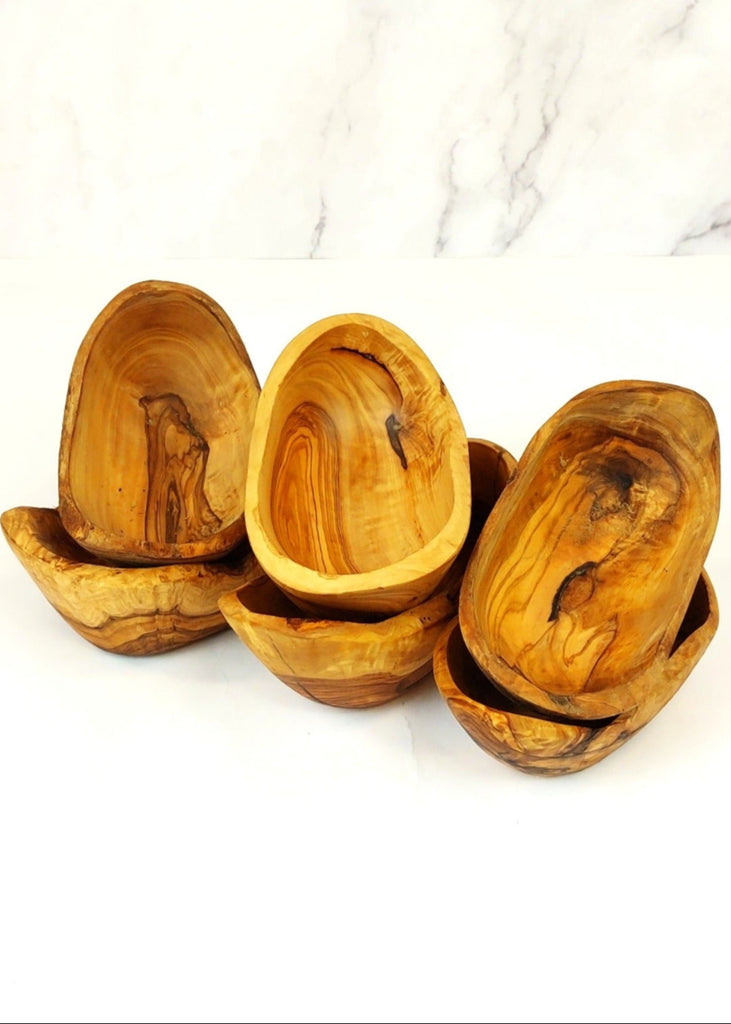 Six small rustic oval serving dishes handcrafted from olive wood, each with unique natural grain patterns