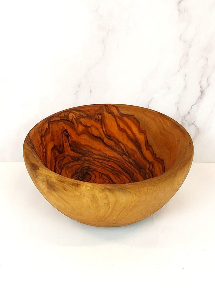 A olive wood salad bowl, showcasing a unique natural grain pattern